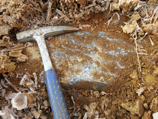 Graphite vein boulder found during build out of road to new drill hole location.