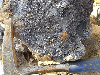 Graphite vein boulder found during build out of road to new drill hole location.